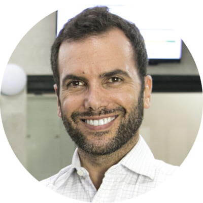 A headshot of Itamar Gero, founder of SEO Reseller. He has short, dark hair, a close-cropped beard, and is wearing a white, button-down shirt with the top button open at the neck. He wrote the article on digital marketing campaigns and his headshot and author bio appear at the bottom.