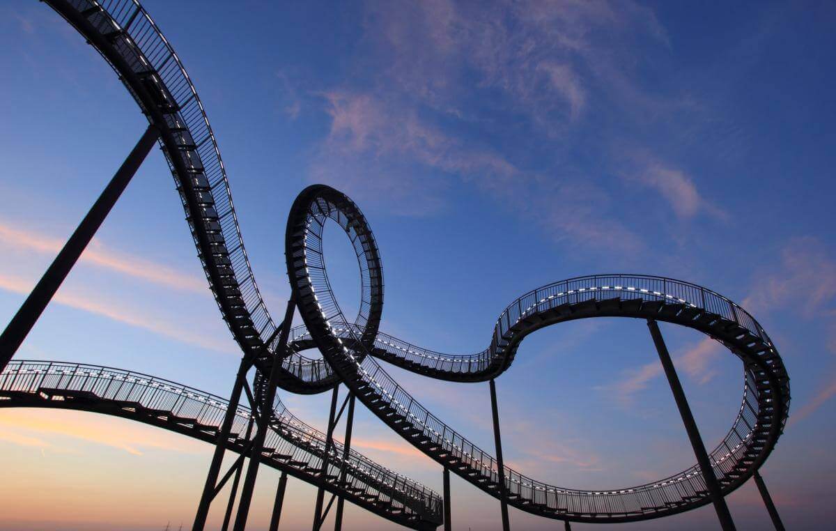 Representing the ups and downs of the entrepreneurial journey, this picture is of a large, winding roller coaster set against a beautiful blue afternoon sky.