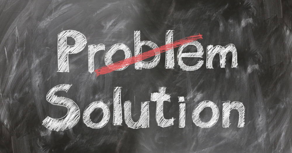 If you want to talk to your boss about a problem, it's best to be solution-focused. This image is a chalkboard with two words written on it in white chalk: "Problem" and "Solution". The word "Problem" is crossed out in red chalk.